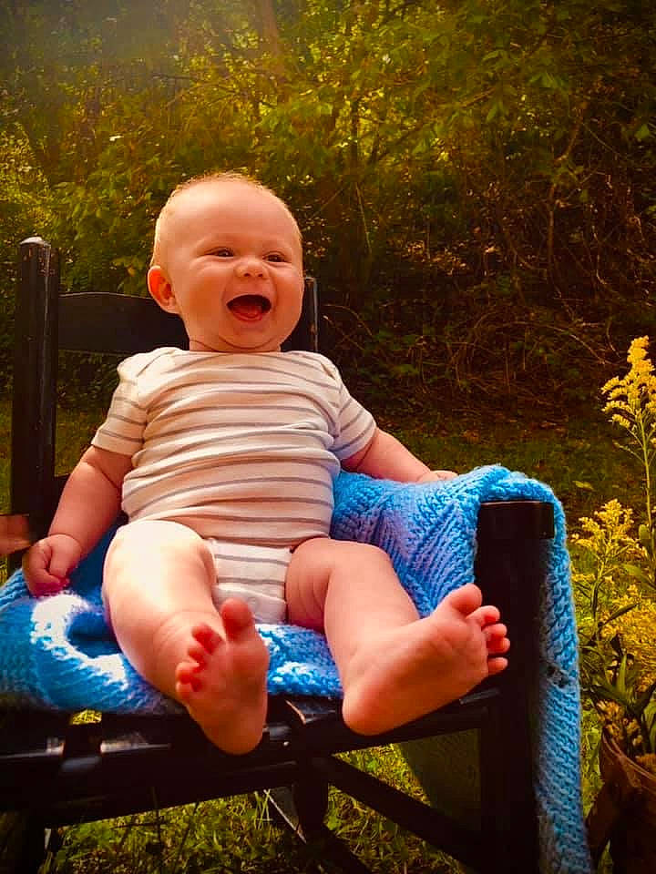 Caney is registered to the contest to win money with this photo: baby, baby_toddler_clothing, eye, facial_expression, flash_photography, fun, grass, happy, leg, leisure, people_in_nature, person, plant, shoe, shorts, smile, standing, sunlight, toddler, tree