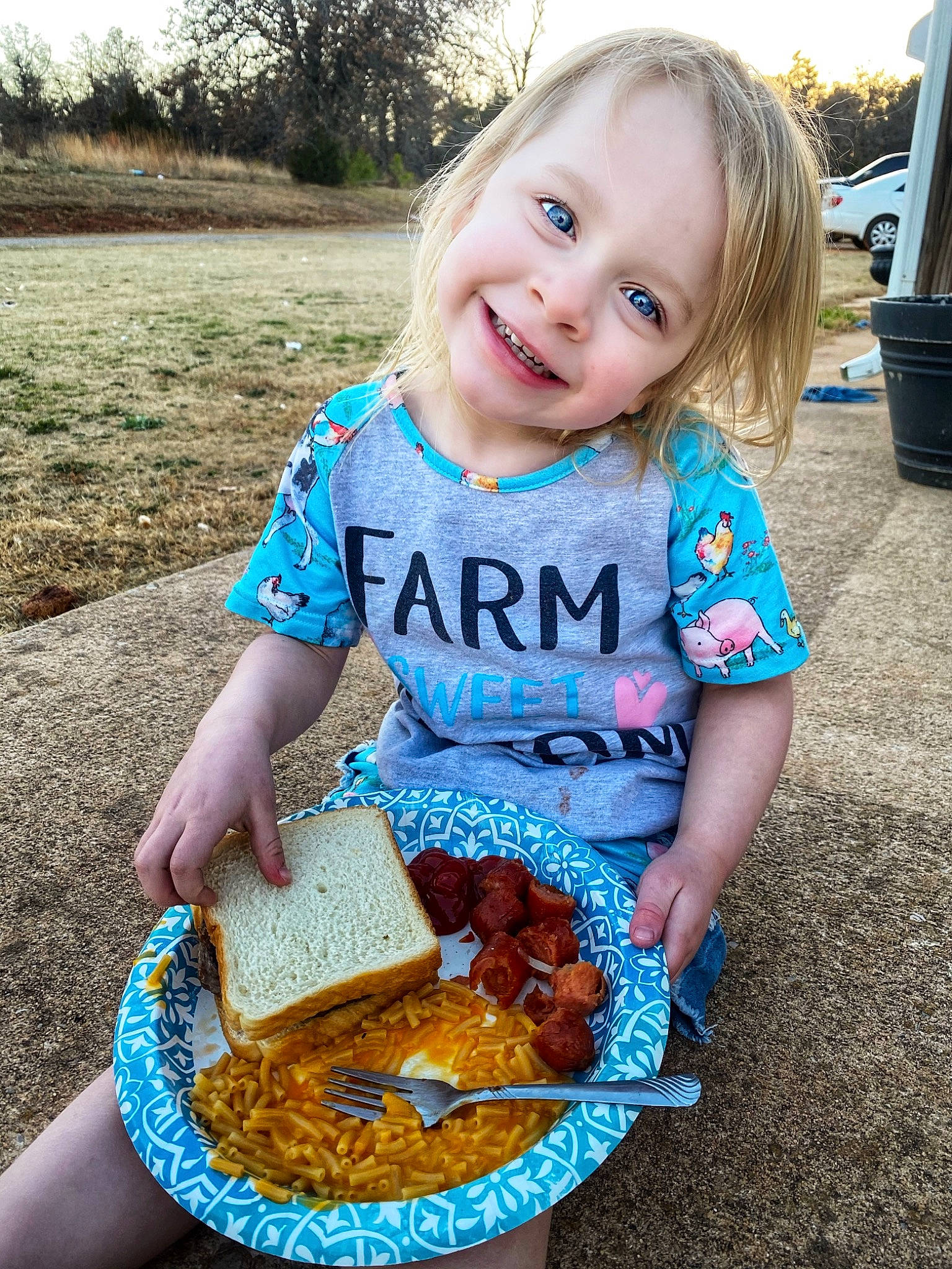 Addie is registered to the contest to win money with this photo: baby_toddler_clothing, baked_goods, bread, child, cuisine, face, food, fun, gluten, grass, happy, ingredient, joy, person, photograph, plant, recipe, smile, summer, t_shirt