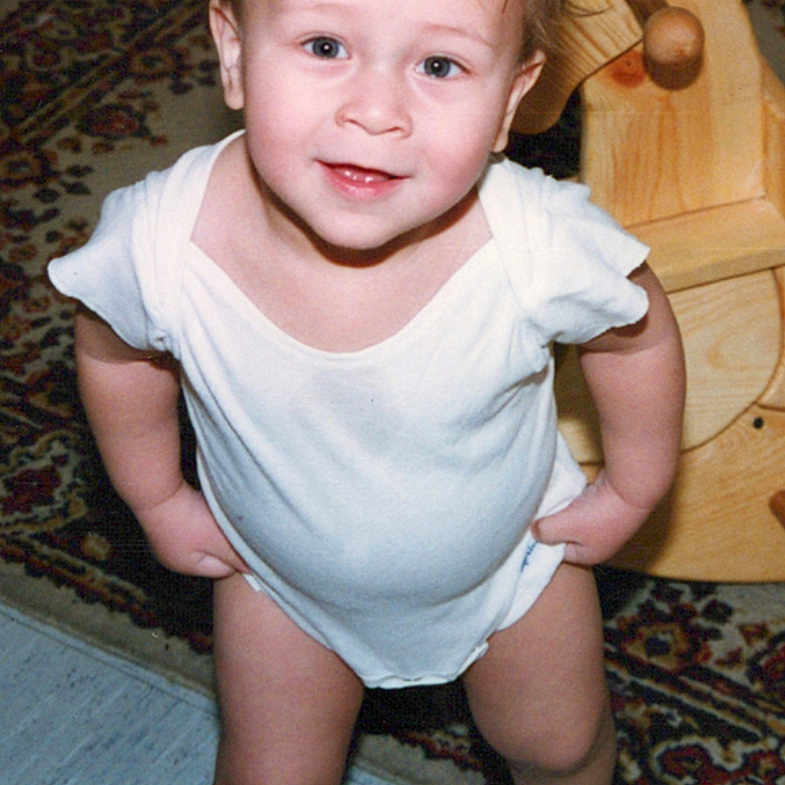 Emmett joined the competition — help win amazing prizes! baby, carpet, child, cute, expression, floor, furniture, happy, home, indoor, person, playroom, portrait, short_hair, smile, standing, toddler, toy, white_onesie, wooden_rocking_horse