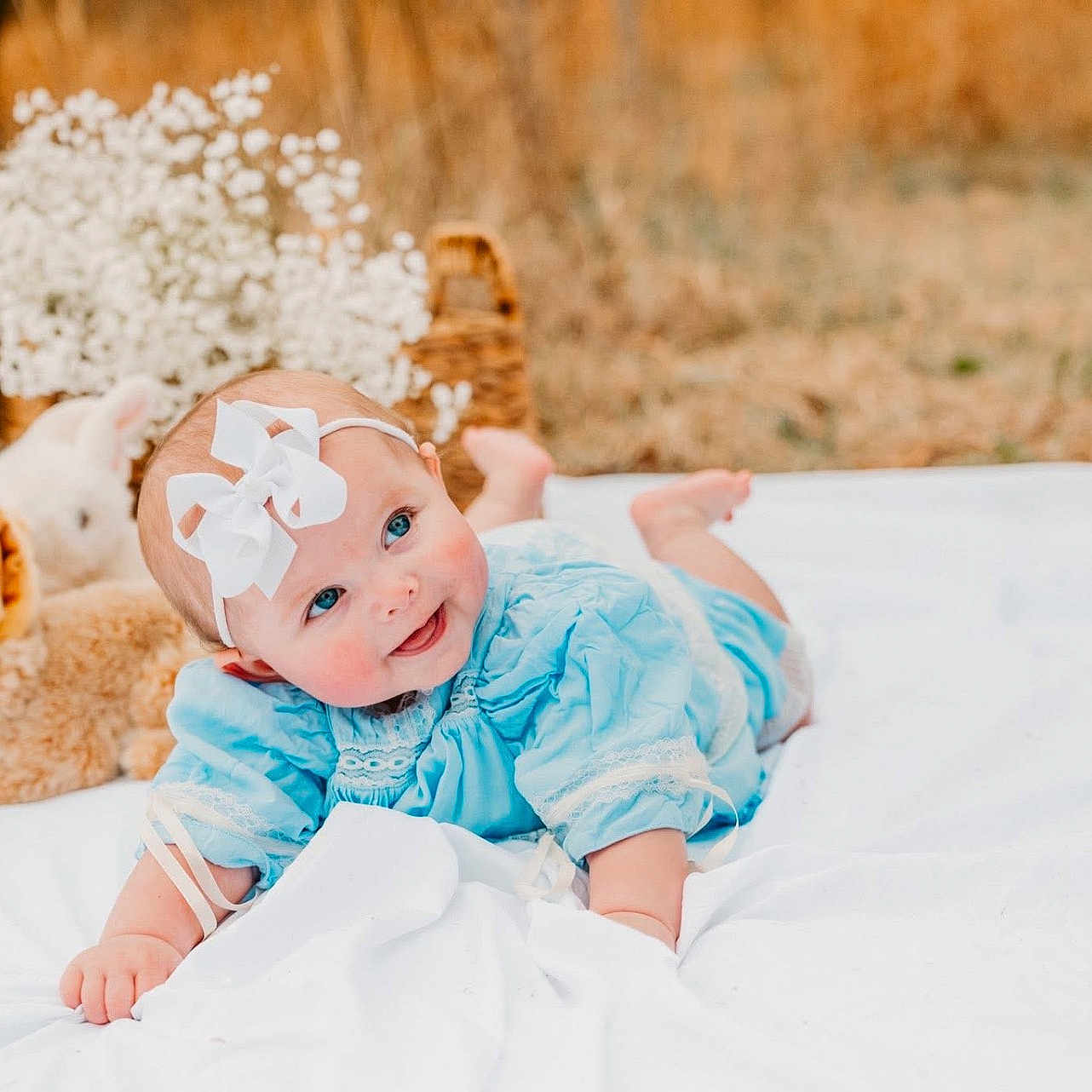 Scottlyn joined the competition — help win amazing prizes! baby, basket, blanket, blue_dress, bow, bunny, cheeks, cute, eyes, flowers, grass, headband, infant, lying_down, outdoor, photography, portrait, smile, soft_toy, stuffed_animal