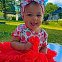 baby, child, tutu, headband, strawberry_pattern, outdoor, grass, smiling, happy, blanket, blue_sky, clouds, greenery, cute, infant, sitting, daylight, portrait, playful, fashion