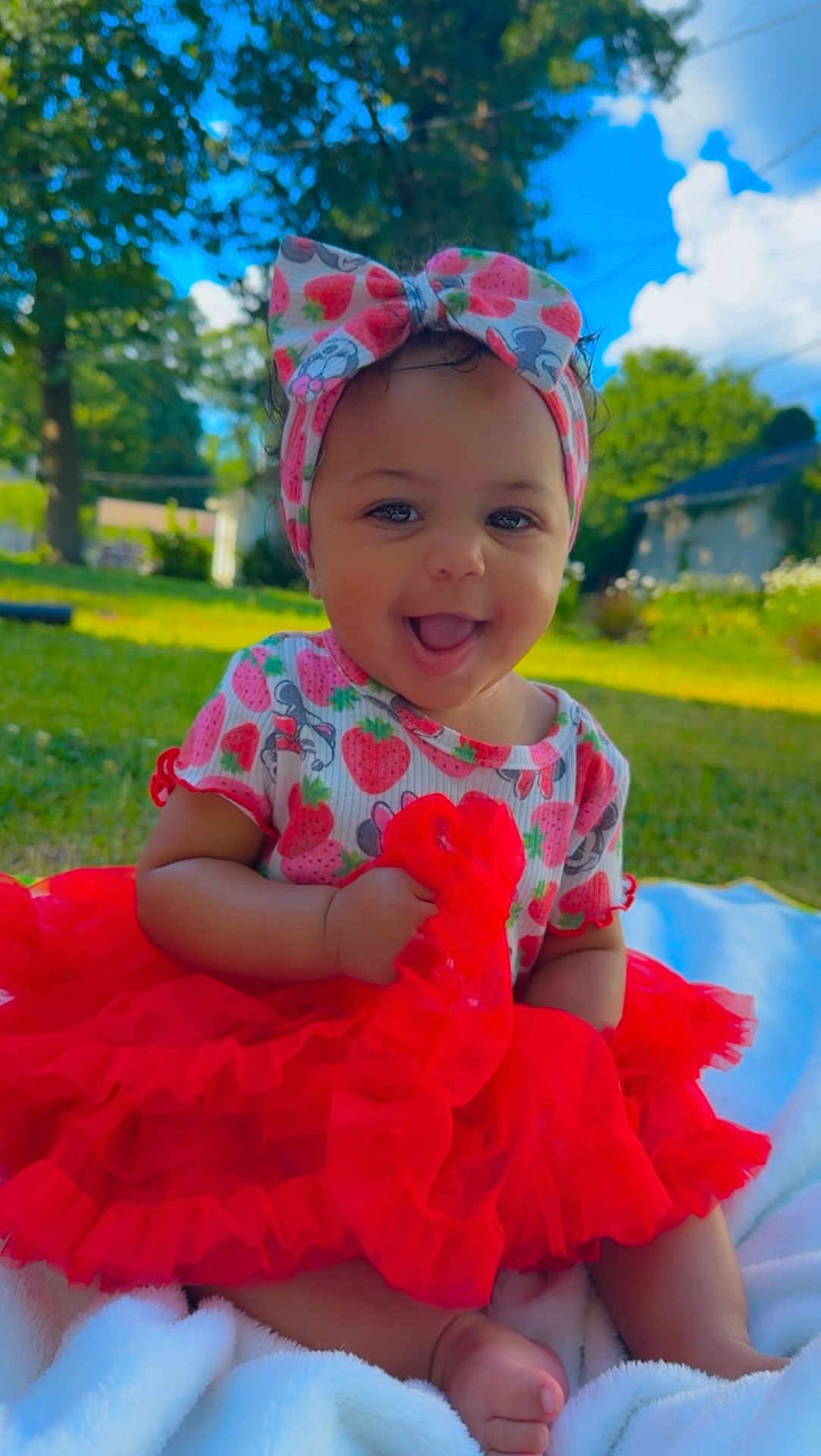 Cimani joined the competition — help win amazing prizes! baby, child, tutu, headband, strawberry_pattern, outdoor, grass, smiling, happy, blanket, blue_sky, clouds, greenery, cute, infant, sitting, daylight, portrait, playful, fashion
