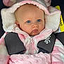 baby, infant, blue_eyes, hoodie, pink_clothing, car_seat, child, cute, fuzzy, warm_clothing, straps, sitting, portrait, face, young_child, bundle, soft_texture, indoors, safety, expression