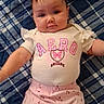 Ellieana is registered to the contest to win money with this photo: baby, infant, child, portrait, lying_down, face, looking_at_camera, calm, cute, smiling, indoor, blanket, patterned_blanket, pink_clothing, white_shirt, butterfly, floral_pants, outstretched_arms, close_up, photography