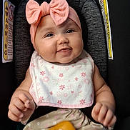 Ellieana is registered to the contest to win money with this photo: baby, infant, car_seat, pink_bow, headband, smiling, happy, portrait, sitting, toy, rattle, bib, floral, clothing, indoor, child, face, arms, legs,  안전