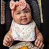 baby, infant, car_seat, pink_bow, headband, smiling, happy, portrait, sitting, toy, rattle, bib, floral, clothing, indoor, child, face, arms, legs,  안전