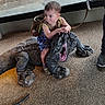 Courtlan is registered to the contest to win money with this photo: child, toddler, komodo_dragon, reptile, indoor, exhibit, sand, glass, backpack, person, animal, hand, leash, footwear, curious, wildlife, captive, petting, adventure, nature
