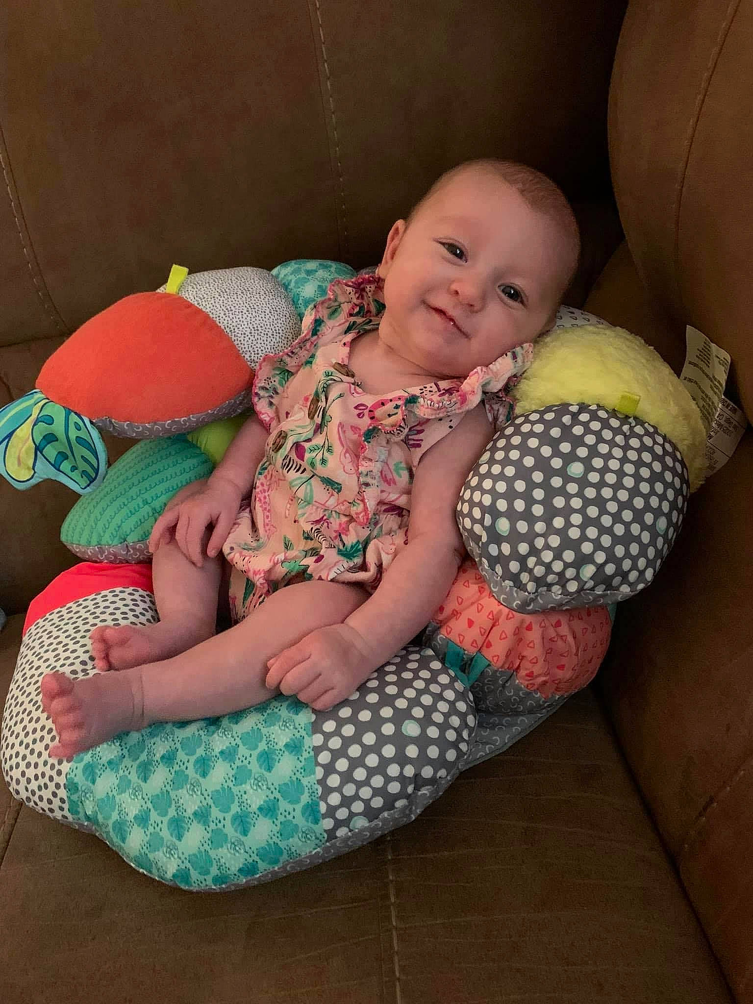 Maisie is registered to the contest to win money with this photo: arm, baby, baby_toddler_clothing, ball, child, comfort, finger, grass, hand, happy, joy, leg, mammal, person, skin, smile, sports_equipment, textile, thigh, toddler