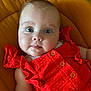 Louise a rejoint le concours — aidez-le/la à gagner de superbes lots ! arm, baby, button, cheeks, child, closeup, cushion, cute, expression, eyes, face, indoors, infant, lying_down, mustard_yellow, person, portrait, red_clothing, ruffles, skin