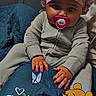 baby, infant, child, pacifier, bonnet, shower_cap, onesie, blanket, winnie_the_pooh, stuffed_character, sitting, portrait, indoor, bedroom, couch, pink_nails, painted_nails, flower_decor, partial_adult, text_overlay