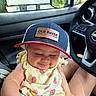 Layla joined the competition — help win amazing prizes! baby, infant, child, portrait, car, vehicle, car_interior, baseball_cap, hat, strawberry, romper, yellow_clothing, sitting, face, eyes_closed, smiling, outdoor_light, steering_wheel, truck, photography