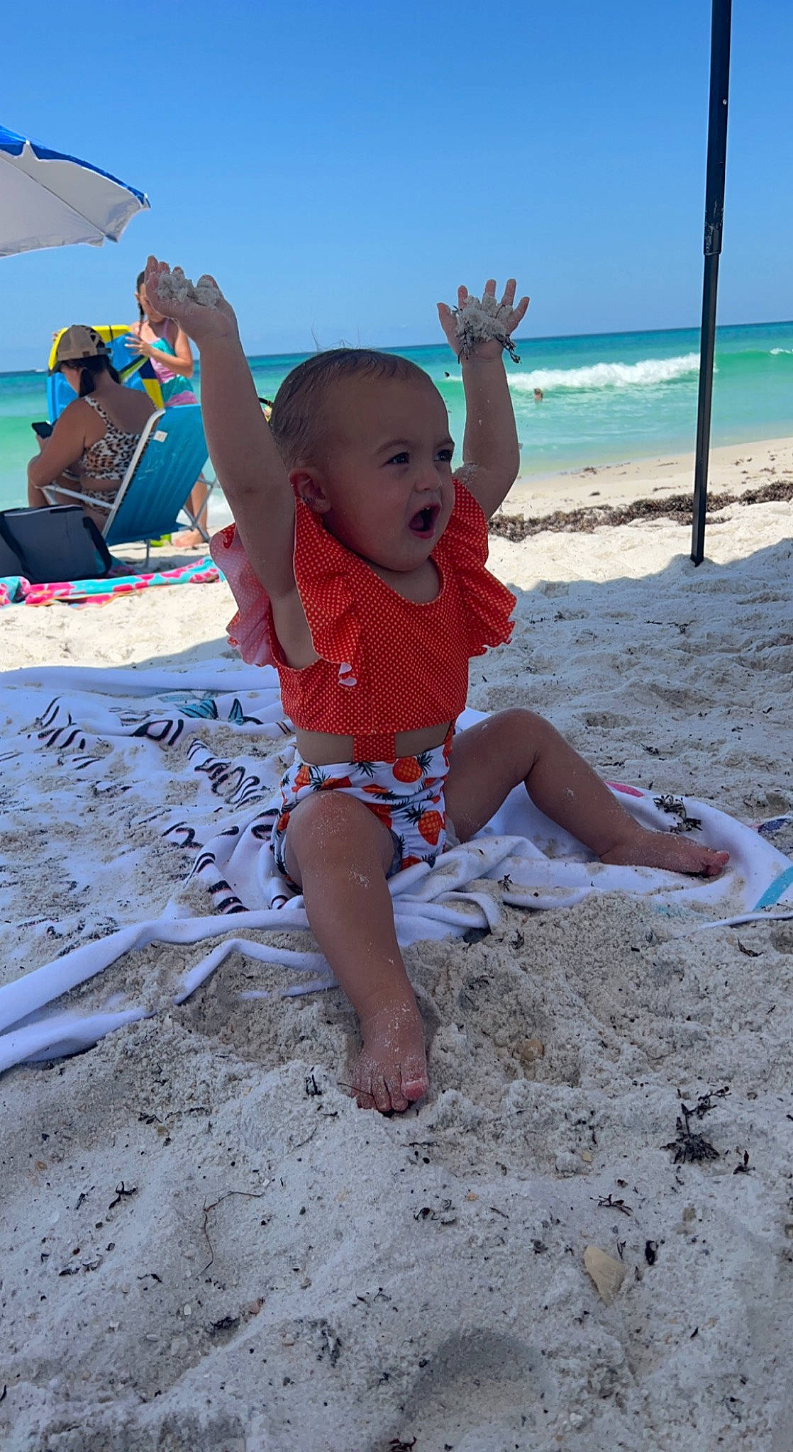Teegan is registered to the contest to win money with this photo: azure, barefoot, beach, body_of_water, foot, fun, happy, holiday, leg, leisure, people_in_nature, people_on_beach, person, sand, shorts, sky, t_shirt, toddler, travel, trunks