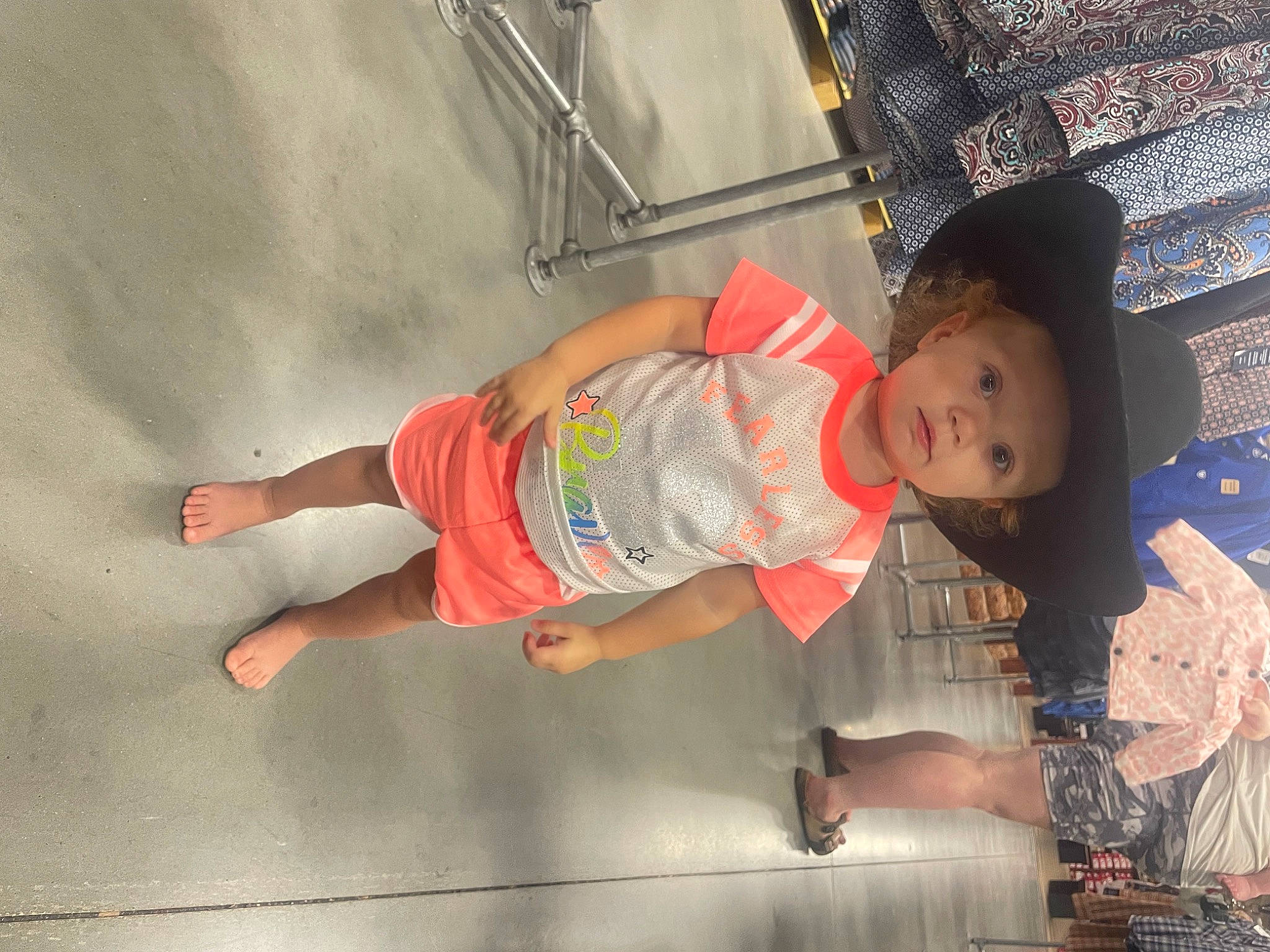 Gabriella is registered to the contest to win money with this photo: baby, baby_toddler_clothing, child, fashion_accessory, foot, fun, happy, hat, headwear, human_leg, knee, leisure, person, sandal, sitting, skin, smile, sun_hat, t_shirt, thigh