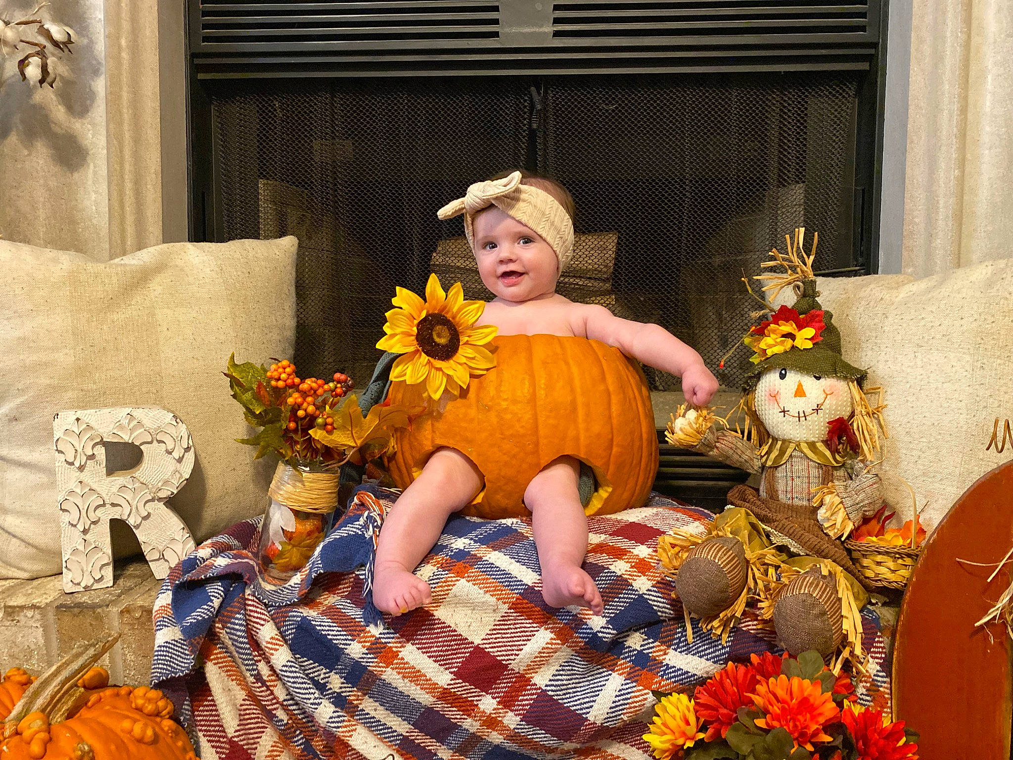 Ryan joined the competition — help win amazing prizes! calabaza, couch, cut_flowers, dress, event, flooring, flower, flower_arranging, gourd, happy, hat, headwear, joy, orange, person, plant, pumpkin, room, sitting, toy