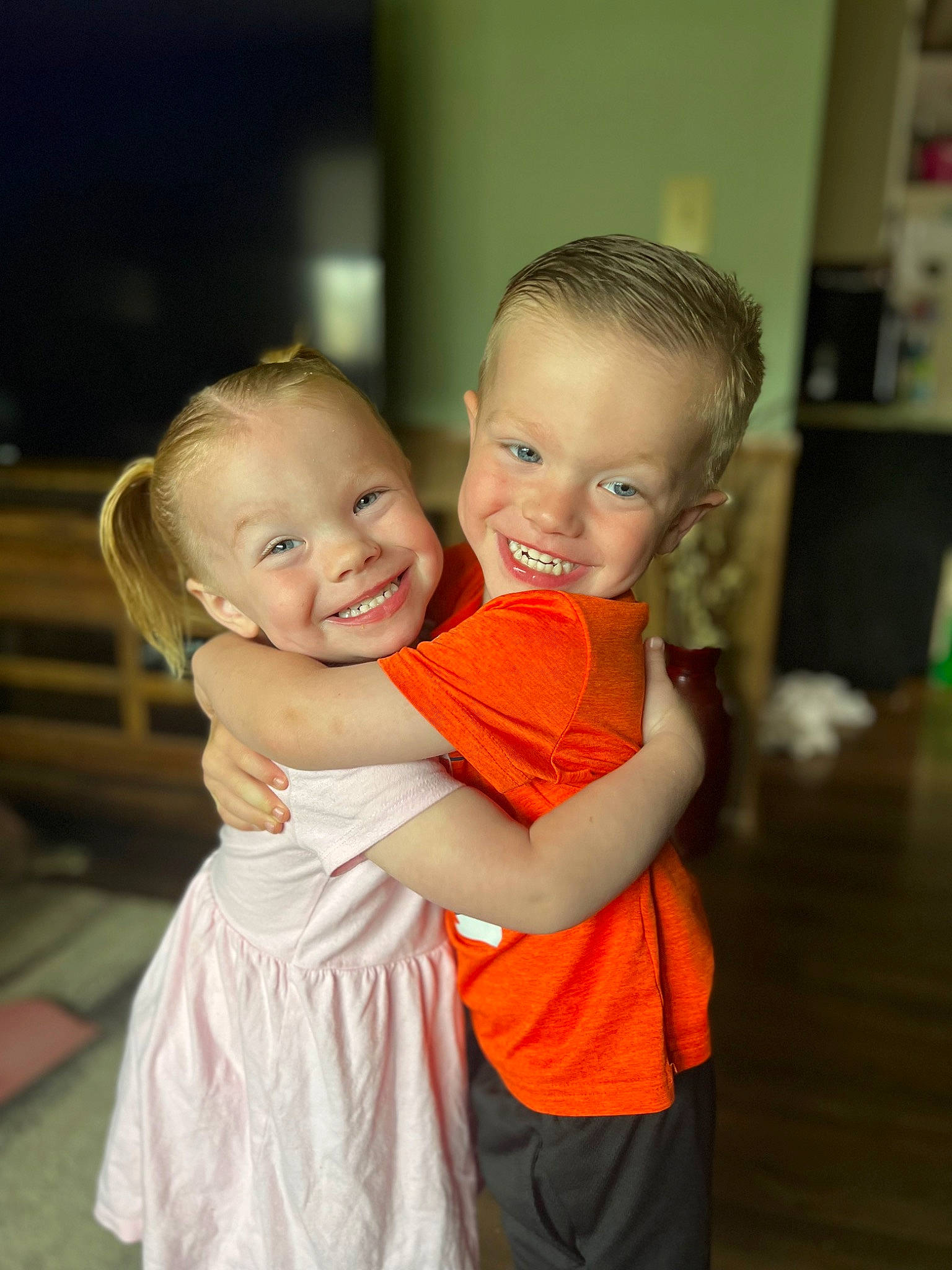 Robin is registered to the contest to win money with this photo: baby_toddler_clothing, blond, cheek, child, dress, event, eye, flash_photography, flooring, formal_wear, fun, gesture, happy, human_body, iris, joy, person, shelf, shoulder, skin