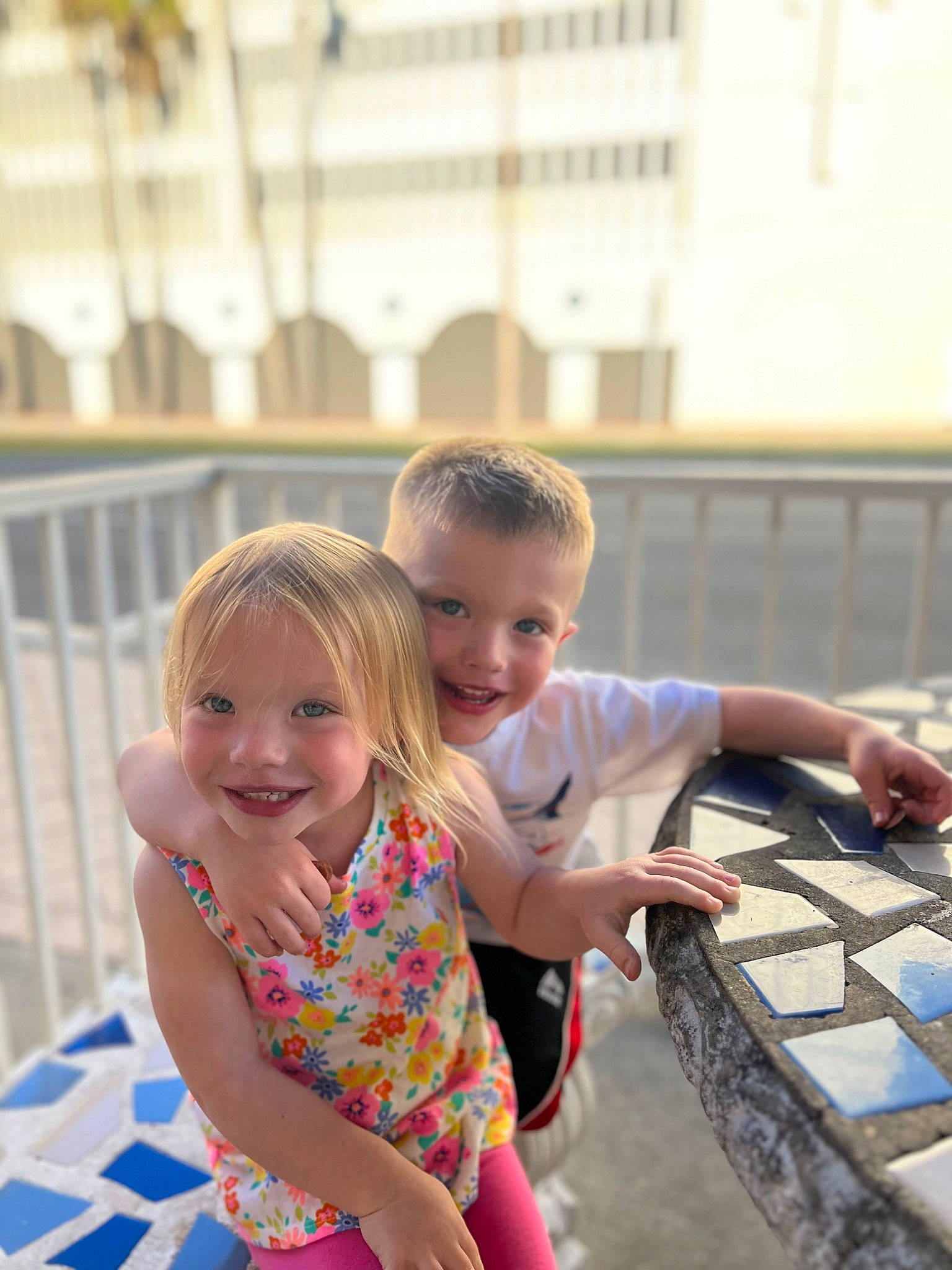 Ryker is registered to the contest to win money with this photo: child, daytime, event, fence, flooring, fun, hairstyle, happy, head, joy, leisure, person, play, recreation, sandal, sitting, smile, t_shirt, toddler, tourism