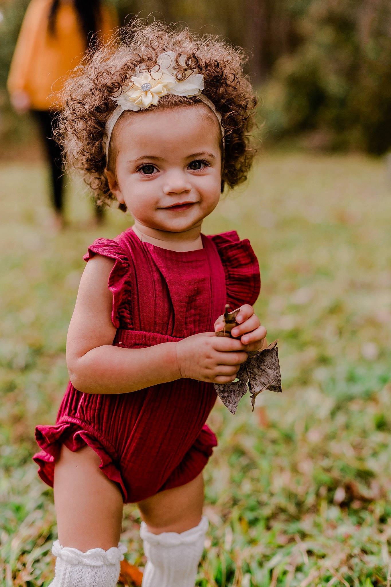 Adalyn is registered to the contest to win money with this photo: baby, beauty, brown_hair, child, child_model, dress, face, grass, hairstyle, head, headgear, joy, people, person, photo_shoot, photograph, photography, red, skin, smile