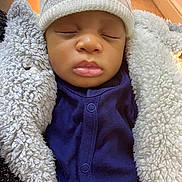 Eugene is registered to the contest to win money with this photo: baby, sleeping, hat, knitted_hat, blue_clothing, fluffy_jacket, cozy, indoor, closeup, infant, child, warm_clothing, cute, peaceful, portrait, soft_texture, human, face, closed_eyes, bundle