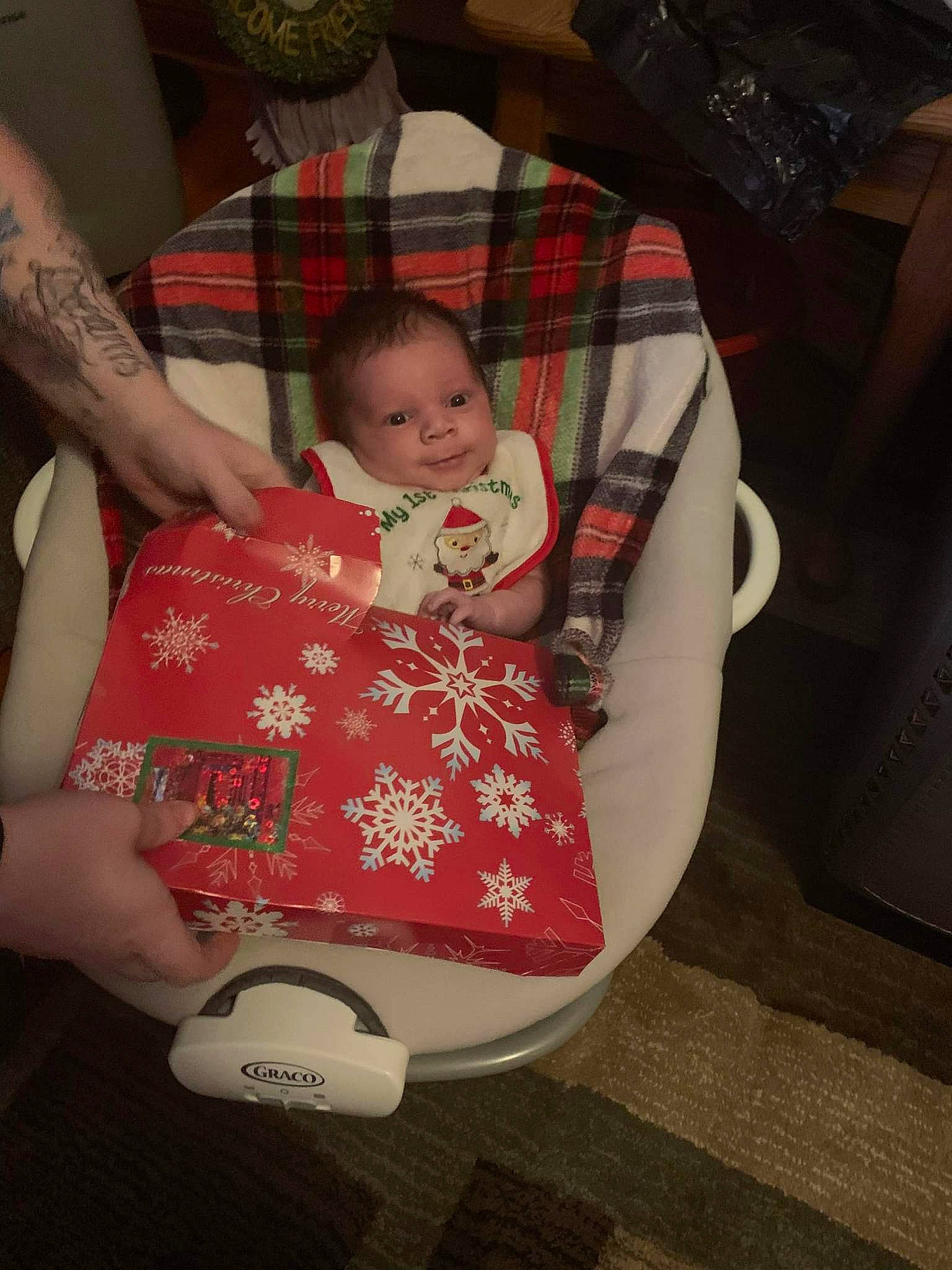 Zayden is registered to the contest to win money with this photo: baby, baby_carriage, baby_products, baby_toddler_clothing, bag, carmine, cheek, child, comfort, human_body, human_leg, knee, lap, pattern, person, plaid, product, sitting, tartan, thigh