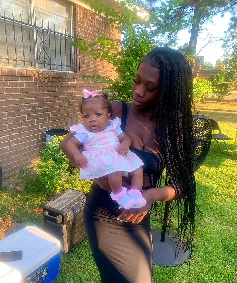 Kenslei is registered to the contest to win money with this photo: baby, child, cooler, event, fun, garden, grass, happy, house, lawn, leisure, person, plant, recreation, shipping_box, sitting, t_shirt, toddler, tree, trunk