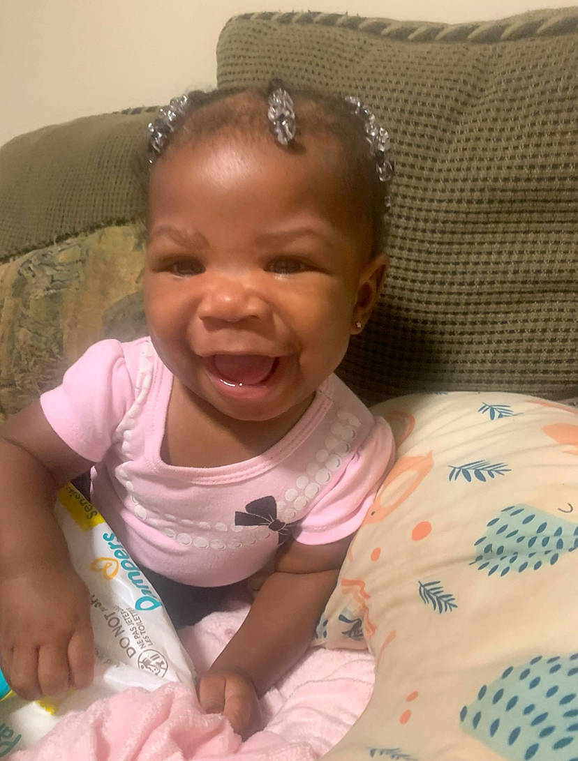 Kenslei is registered to the contest to win money with this photo: baby, baby_toddler_clothing, cheek, comfort, eye, eyebrow, face, fun, happy, head, iris, lip, mouth, nose, person, pink, skin, sleeve, smile, textile