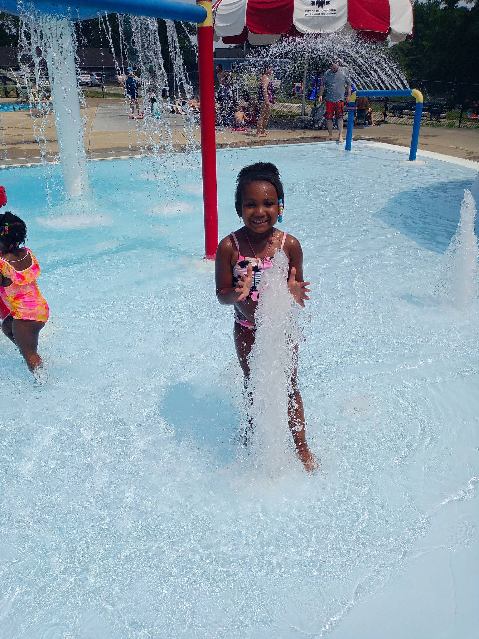 Zoë is registered to the contest to win money with this photo: bathing, chute, composite_material, freezing, fun, happy, joy, leisure, nonbuilding_structure, person, playground, recreation, smile, snapshot, summer, swimming_pool, toddler, vacation, water, water_feature