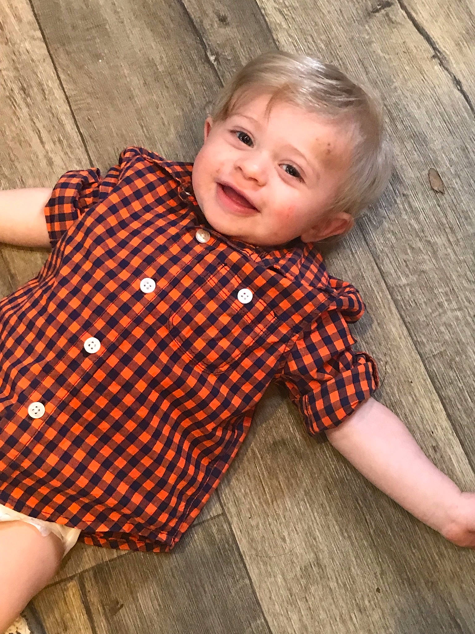 Samual is registered to the contest to win money with this photo: baby, baby_products, baby_toddler_clothing, child, child_model, design, dress, floor, flooring, neck, outerwear, pattern, person, product, sleeve, toddler, wood