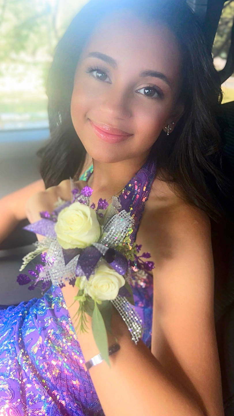 Emily is registered to the contest to win money with this photo: black_hair, cool, eye, eyelash, face, fashion, fashion_design, flash_photography, flower, happy, head, iris, joy, lip, necklace, organ, person, petal, plant, purple