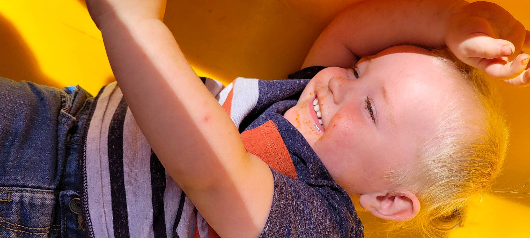 Elijah is registered to the contest to win money with this photo: baby, baby_toddler_clothing, cheek, eyelash, facial_expression, finger, fun, happy, human, iris, joy, lip, mouth, neck, nose, orange, person, skin, smile, summer