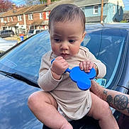 Yetzael is registered to the contest to win money with this photo: baby, bodypart, car, city, clothing, face, finger, hand, head, neighborhood, person, photography, portrait, road, shorts, sitting, street, transportation, urban, vehicle