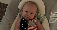 Kyle is registered to the contest to win money with this photo: baby, infant, child, baby_seat, cushion, clothing, indoor, portrait, smile, face, foot, hand, carpet, blanket, head_support, person, relaxing, cute, young, domestic
