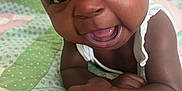 Makayla is registered to the contest to win money with this photo: accessories, baby, babylaughing, bed, bedroom, bodypart, face, happy, head, jewelry, laughing, mouth, necklace, person, photography, portrait, quilt, sitting, smile, teeth