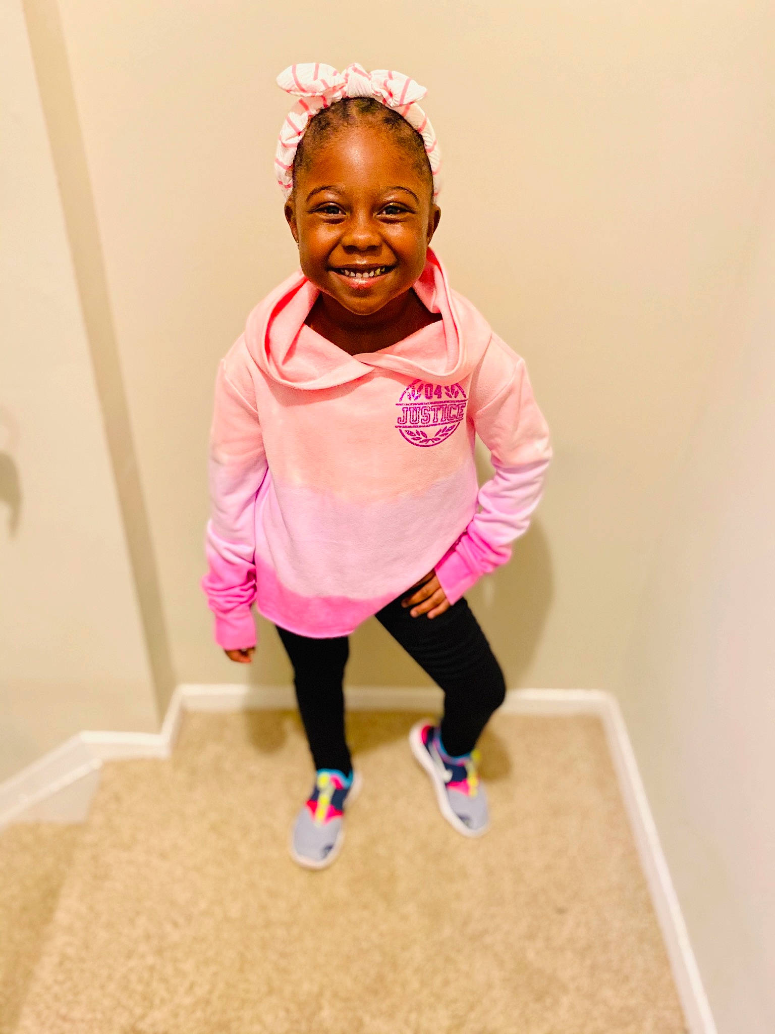 Milan is registered to the contest to win money with this photo: arm, baby_toddler_clothing, cheek, child, face, fashion_accessory, finger, fun, gesture, hair, hand, happy, head, joy, magenta, person, pink, room, sleeve, smile