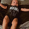 Desmond joined the competition — help win amazing prizes! baby, infant, bed, onesie, text_clothing, pillow, blanket, relaxed, arms_outstretched, sleepy, indoor, person, cute, child, young, clothing, lying_down, soft_lighting, cozy, nautica