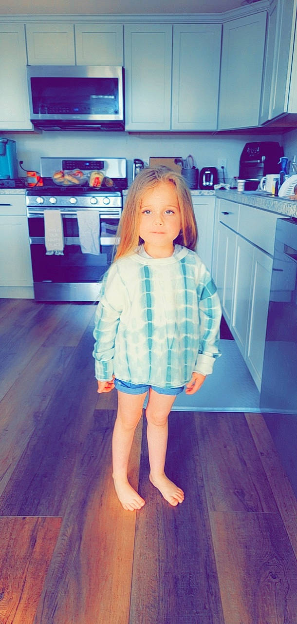 Gabriella joined the competition — help win amazing prizes! azure, cabinetry, countertop, dress, electric_blue, floor, flooring, fun, hardwood, home_appliance, joint, kitchen, kitchen_appliance, laminate_flooring, person, shoulder, sleeve, standing, t_shirt, waist