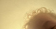 Rarri is registered to the contest to win money with this photo: child, curly_hair, pacifier, close_up, blurry, face, indoor, ceiling, baby, portrait, skin, head, expression, young_child, person, infant, toddler, light, shadow, casual