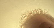 Rarri is registered to the contest to win money with this photo: baby, blurry, ceiling, child, close_up, curly_hair, cute, expression, face, head, human, indoor, infant, looking_down, pacifier, person, portrait, skin, soft_light, young