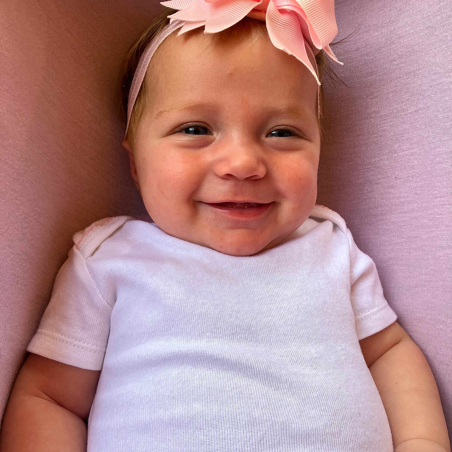 Rhedyn joined the competition — help win amazing prizes! baby, smiling, headband, pink_bow, white_onesie, infant, portrait, closeup, cute, child, soft_background, happy, skin, face, hand, clothing, young_child, indoor, person, baby_girl