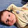 Atlas is registered to the contest to win money with this photo: adorable, baby, baby_clothing, blue_blanket, brown_hair, cartoon_character, child, close_up, cozy, face, facial_expression, indoor, infant, lying_down, onesie, photography, portrait, wide_eyed, winnie_the_pooh, yellow_clothing
