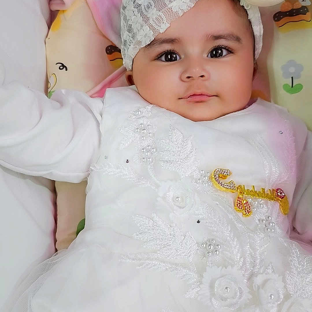 Haniya Kazmi is registered to the contest to win money with this photo: baby, bed, blanket, bonnet, cap, clothing, costume, cushion, dress, face, formalwear, furniture, hat, head, homedecor, newborn, people, person, photography, portrait