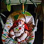 baby, baby_accessory, baby_swing, child, colorful, cozy, cute, hat, indoor, infant, napping, pacifier, patterned_fabric, peaceful, resting, sleeping, small_hands, soft_lighting, toy, wearing_clothes