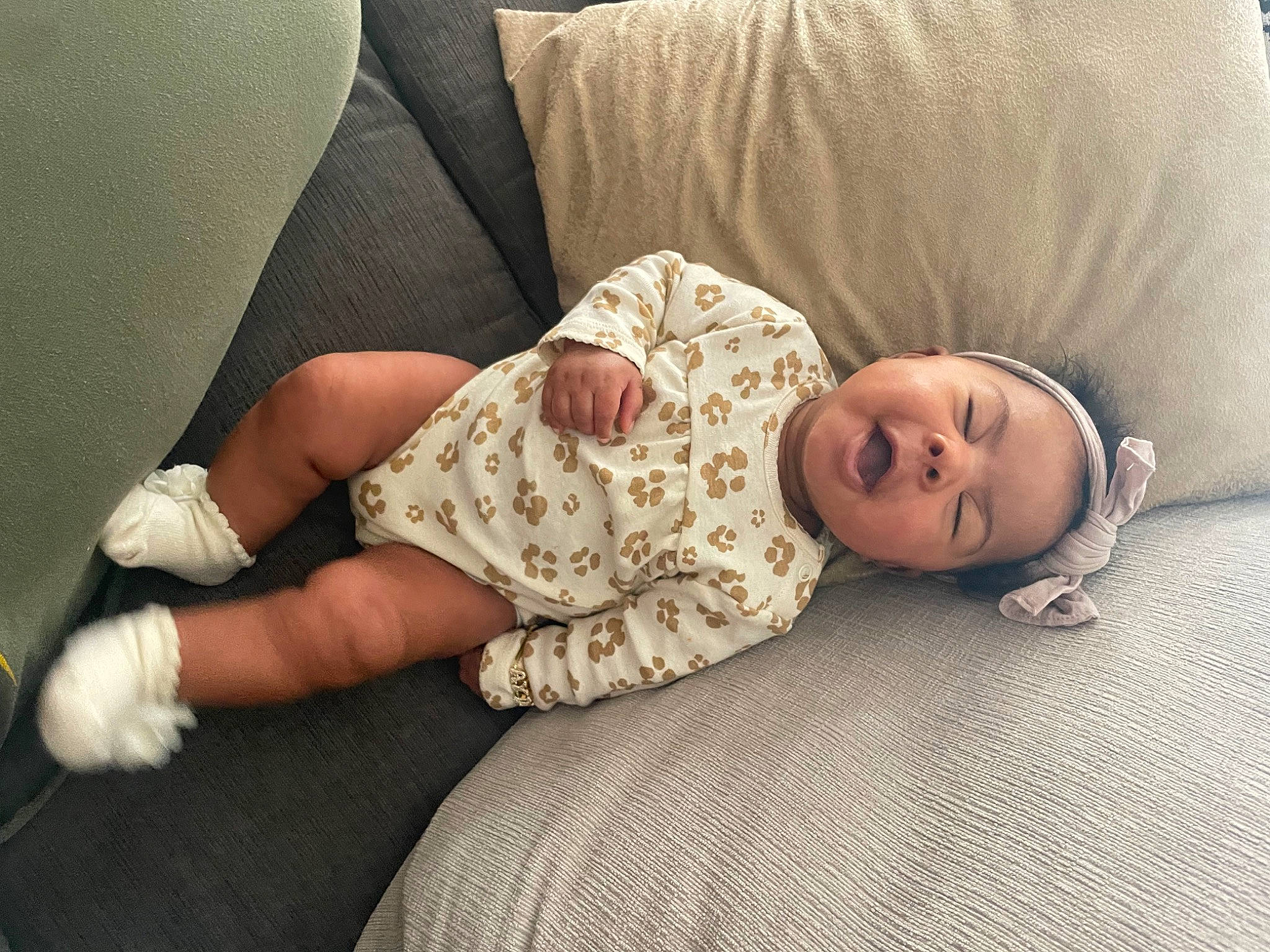 Aydn is registered to the contest to win money with this photo: baby, baby_toddler_clothing, child, comfort, elbow, finger, flooring, head, human_leg, joint, knee, leg, linens, person, sitting, skin, sleeve, thigh, toddler, watch
