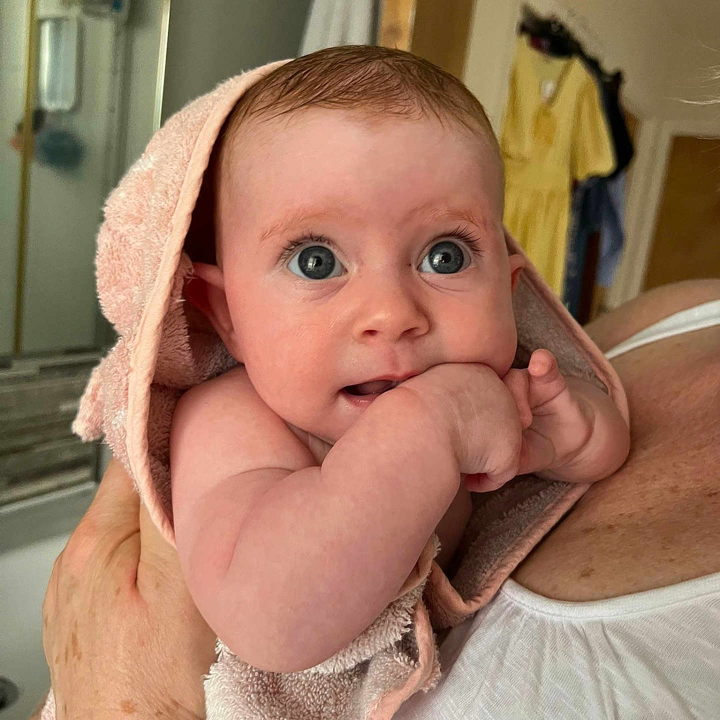 Nova joined the competition — help win amazing prizes! adult, arm, baby, bathroom, blue_eyes, closeup, clothing, curious, expression, face, hand, holding, indoor, infant, person, skin, skin_detail, soft_texture, towel, watch