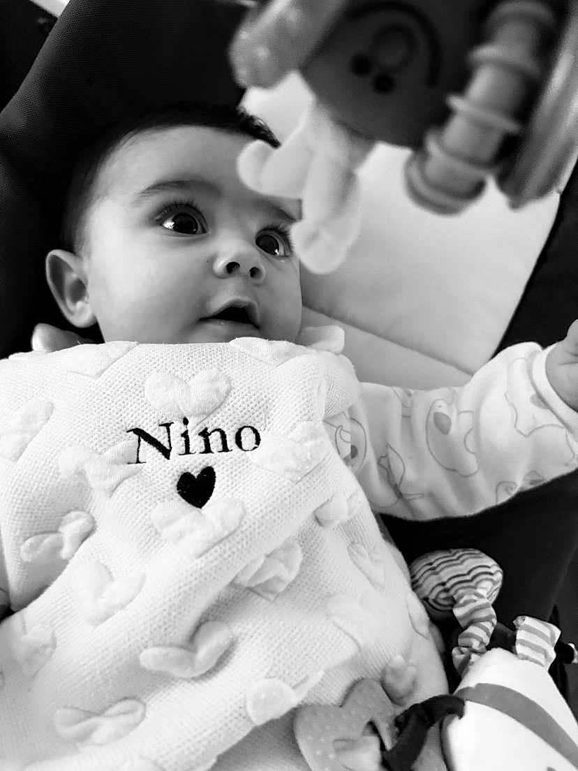 Nino participe au concours pour gagner de l'argent avec cette photo : baby, infant, blanket, heart_pattern, toy, black_and_white, closeup, curious, child, face, eyes, clothing, cute, indoors, portrait, soft_texture, young, expression, wrapped, cozy