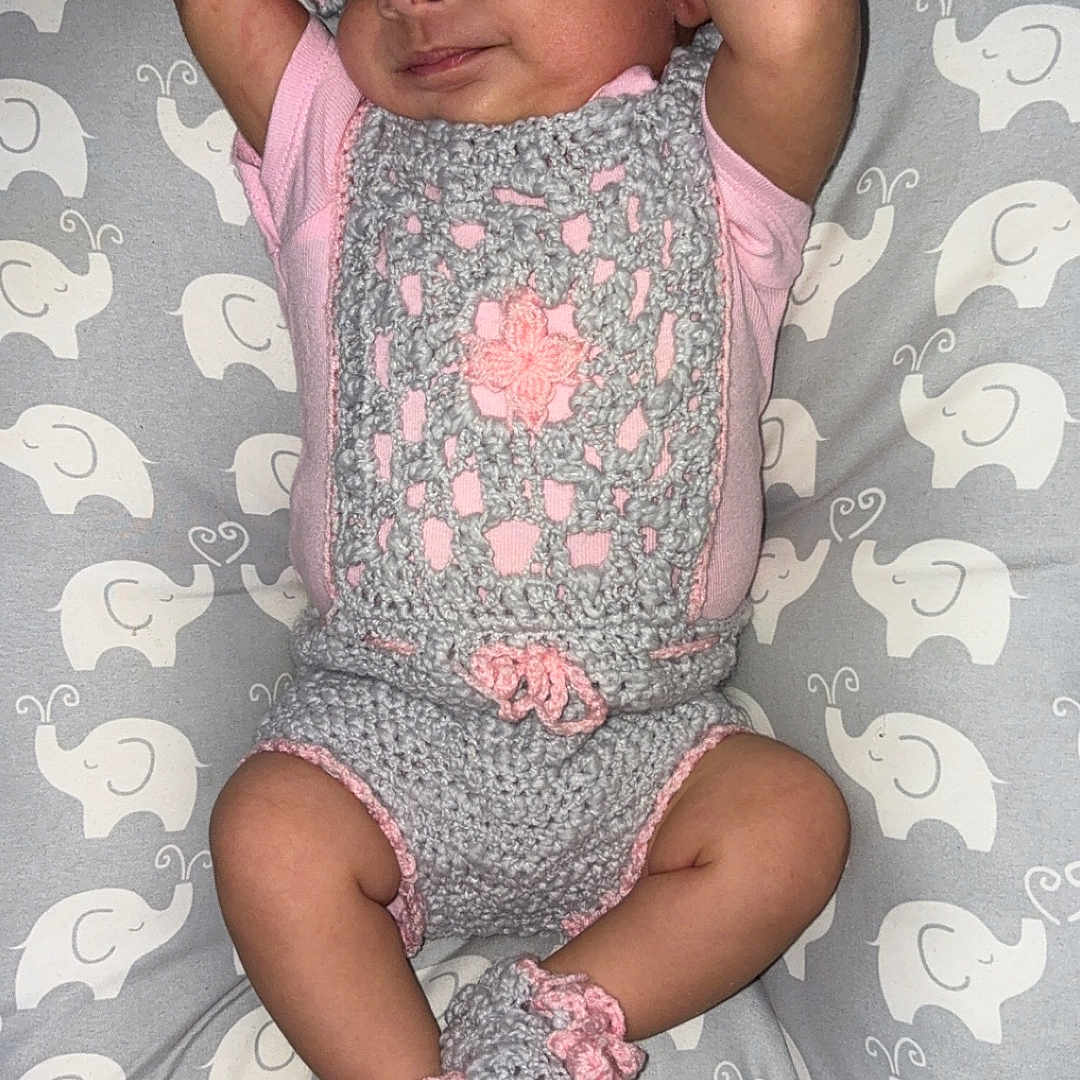 Yolyn joined the competition — help win amazing prizes! arms_up, baby, booties, child, cozy, crocheted_outfit, cushion, cute, elephant_pattern, gray, hat, indoors, infant, lying_down, newborn, peaceful, pink, resting, sleeping, soft_texture