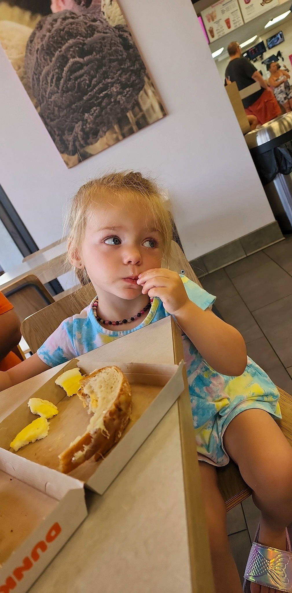 Blakelee is registered to the contest to win money with this photo: blurred, breakfast, chair, child, comfort_food, cuisine, dish, eating, flooring, food, food_craving, fun, junk_food, person, picture_frame, room, sharing, sitting, sweetness, table