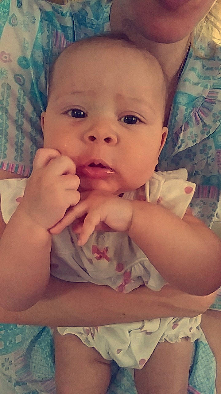 Aylani is registered to the contest to win money with this photo: arm, baby, cheek, child, chin, eye, face, facial_expression, finger, forehead, head, human, iris, lip, mouth, nose, organ, person, skin, smile