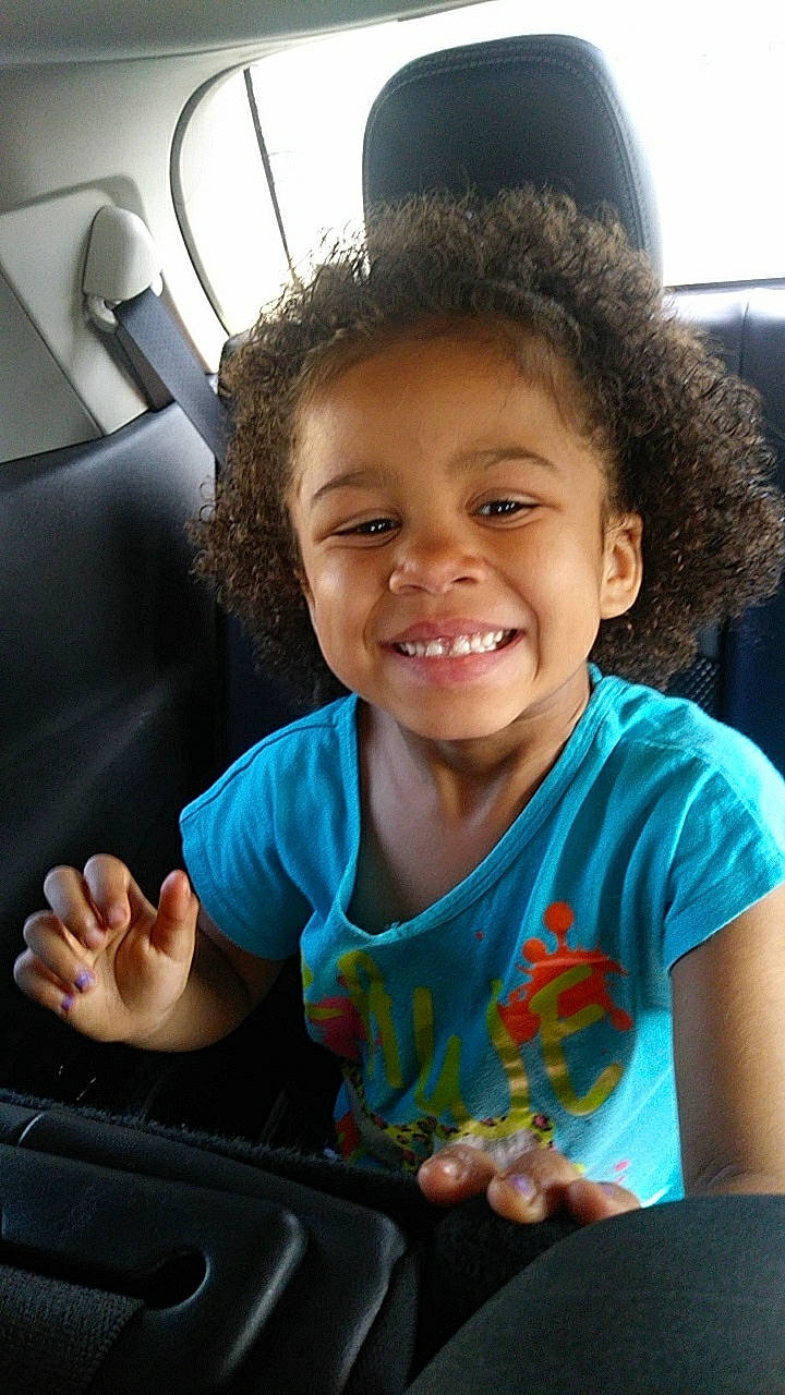 Aili is registered to the contest to win money with this photo: child, electronic_device, facial_expression, finger, fun, gesture, hand, happy, joy, laugh, person, play, skin, smile, technology, thumb, toddler, tooth, vacation