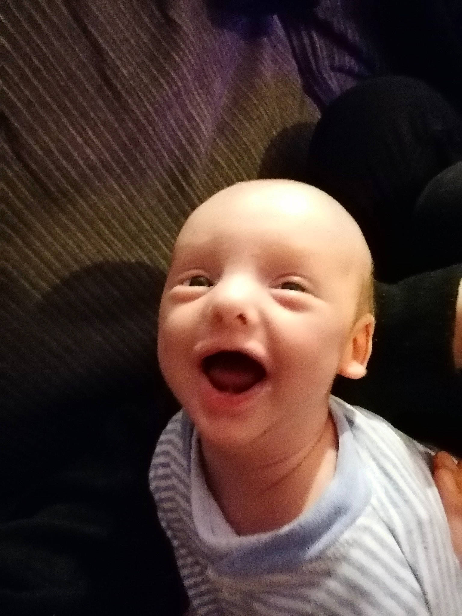 Reginald is registered to the contest to win money with this photo: baby, cheek, cloud, comfort, ear, eyebrow, eyelash, face, flash_photography, gesture, happy, head, human_body, jaw, lip, nose, person, sleeve, smile, toddler