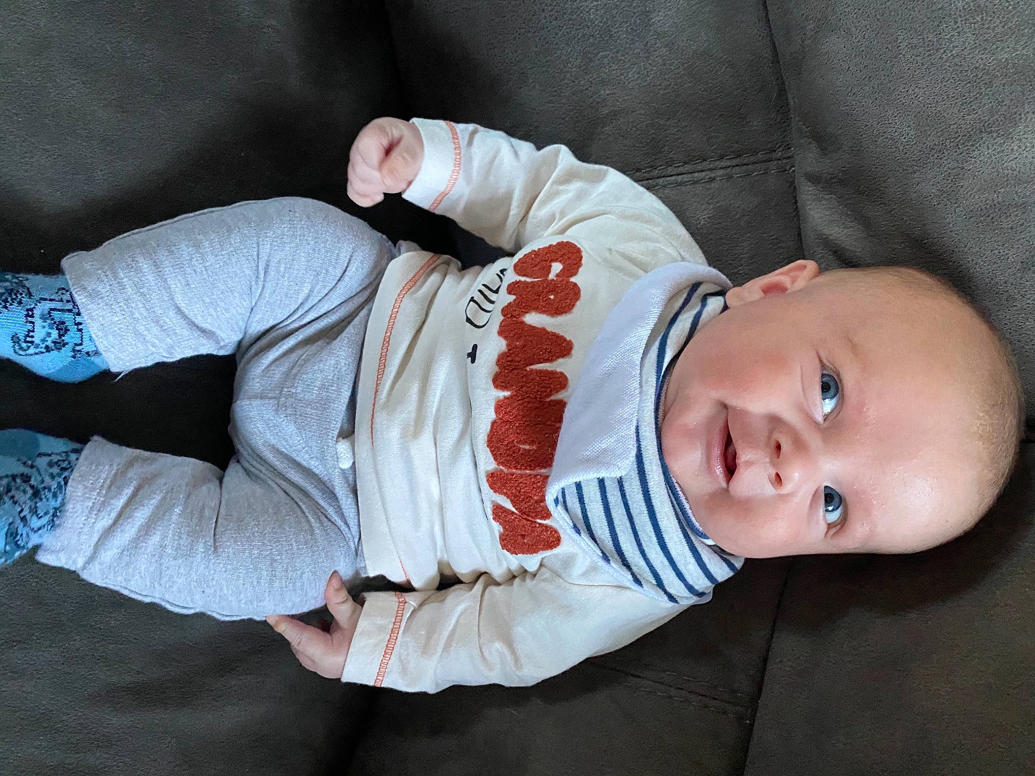 Chester is registered to the contest to win money with this photo: arm, baby, baby_toddler_clothing, cheek, comfort, face, finger, hand, headgear, human_body, lip, mammal, mouth, nose, outerwear, person, skin, sleeve, smile, textile